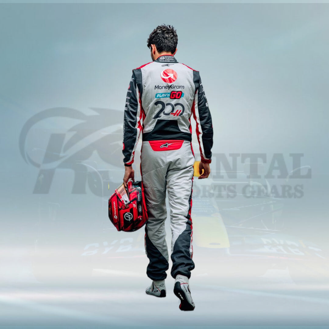 Person in a racing suit holding a helmet with a blurred background